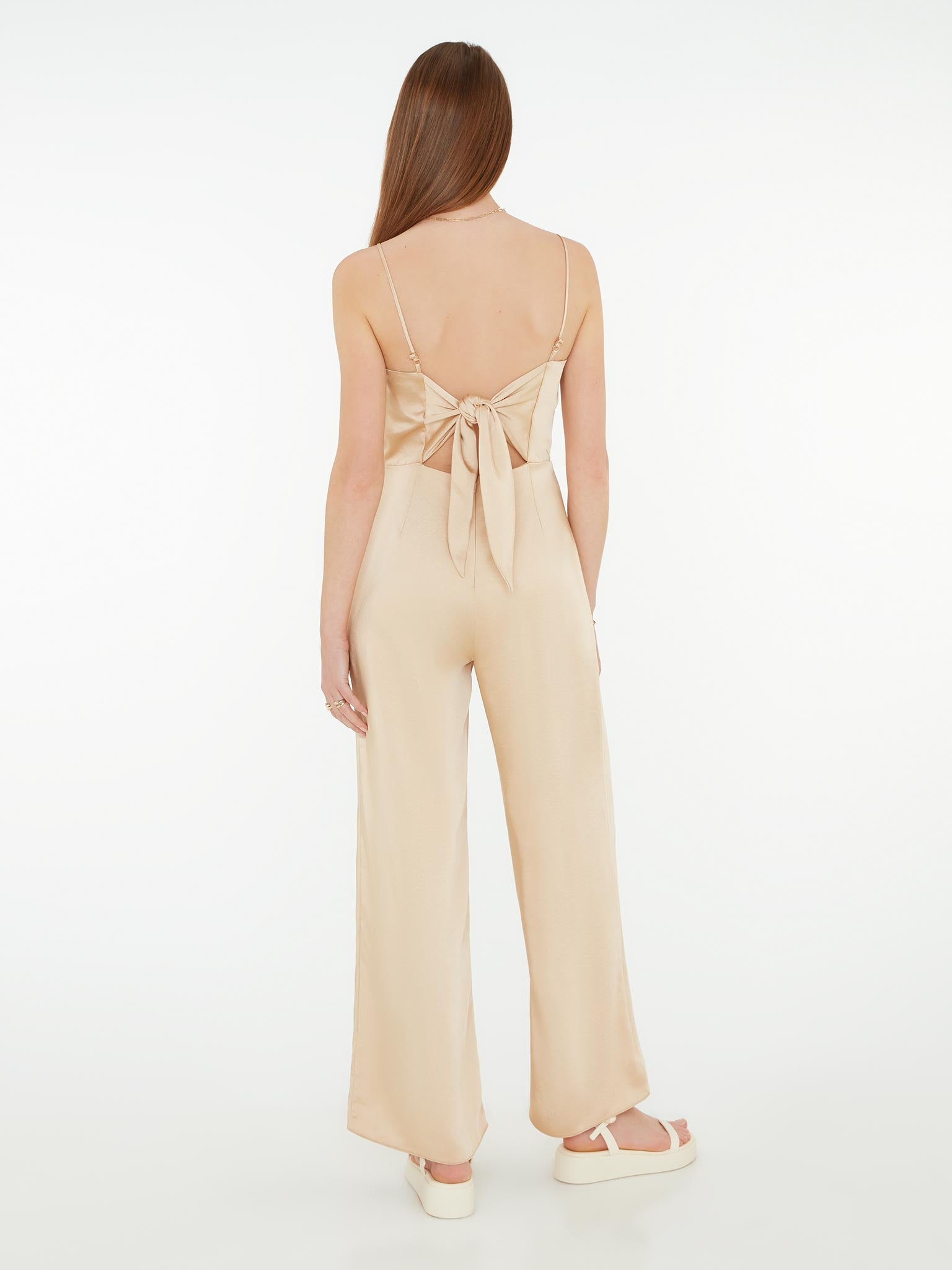 strappy jumpsuit in gold with tie back detail